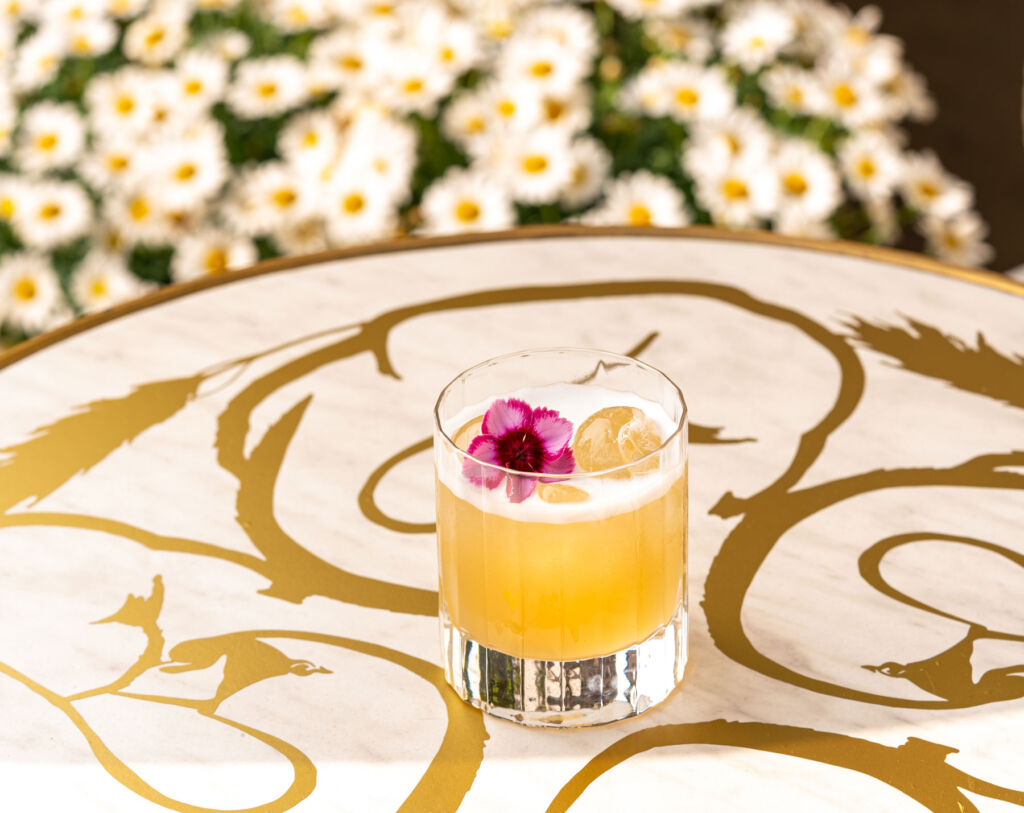 The flora cocktail garnished with flower petals