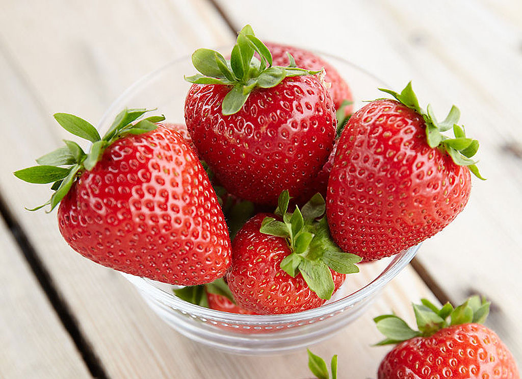 Fresh strawberries in a glass container