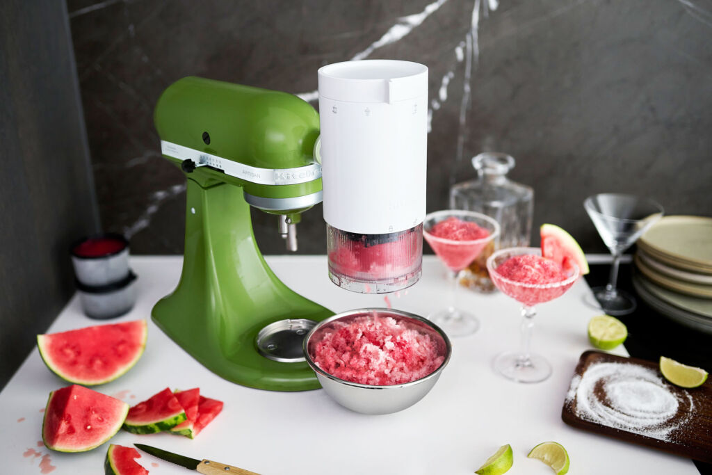 The ice shave attachment is attached to a green mixer to make Watermelon Margaritas