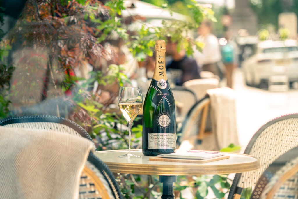 A bottle of chilled champagne ready for guests on a table