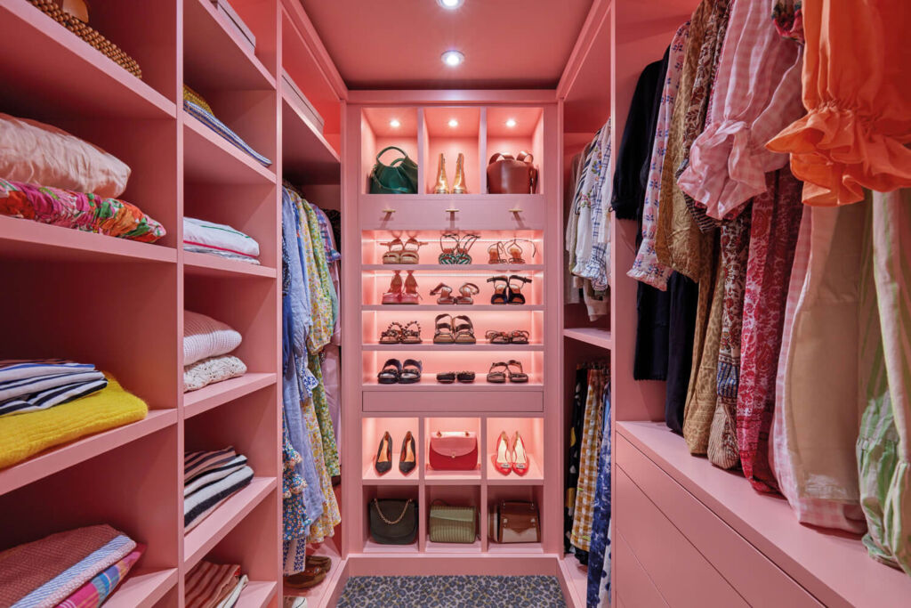 A walk-in wardrobe painted in bright pink