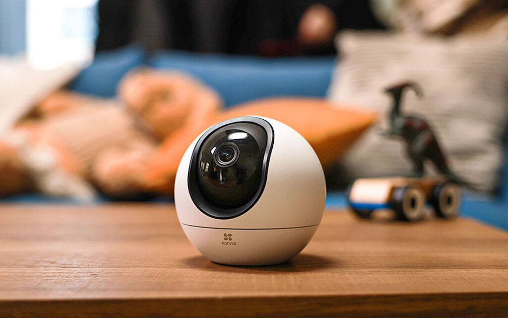 The C6 AI Smart Camera on a table in a bedroom