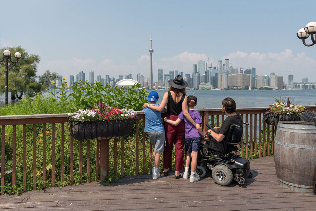 A family looking at the Toronto skyline from the waterfront