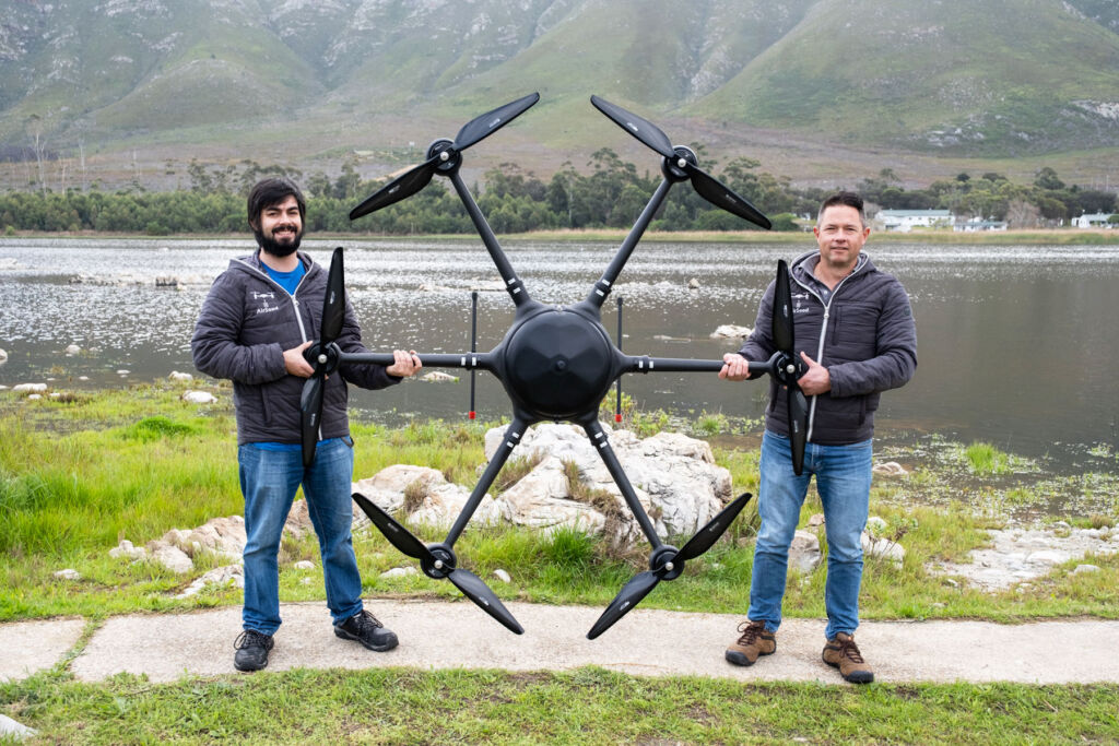 Company representatives either side of the giant drone