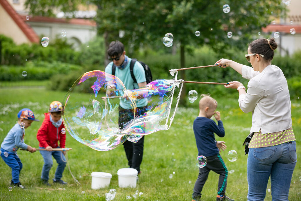 A family creating giant bubbles in the park