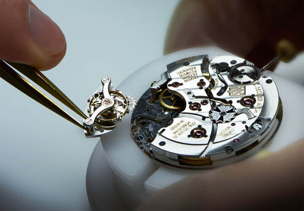 One of the company's expert watchmakers assembling a movement