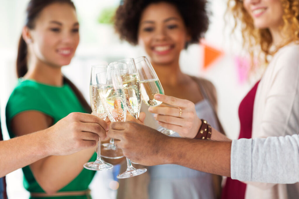 Three ladies enjoying glasses of bubbly at a party