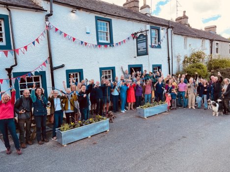 members of the local community celebrating outside the pub