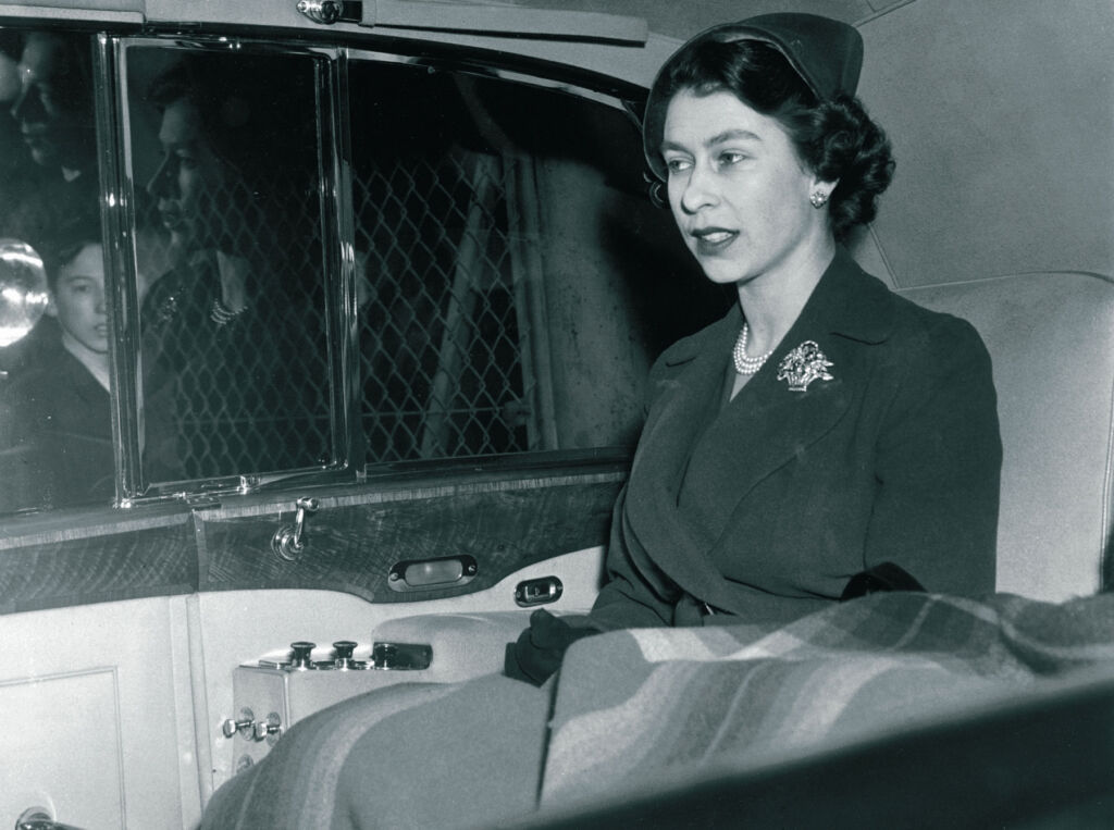 A young Queen Elizabeth II travelling in the state car
