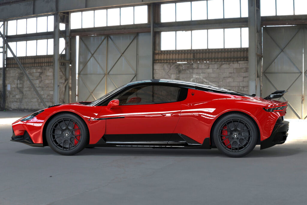A side profile view of the red supercar in a hangar