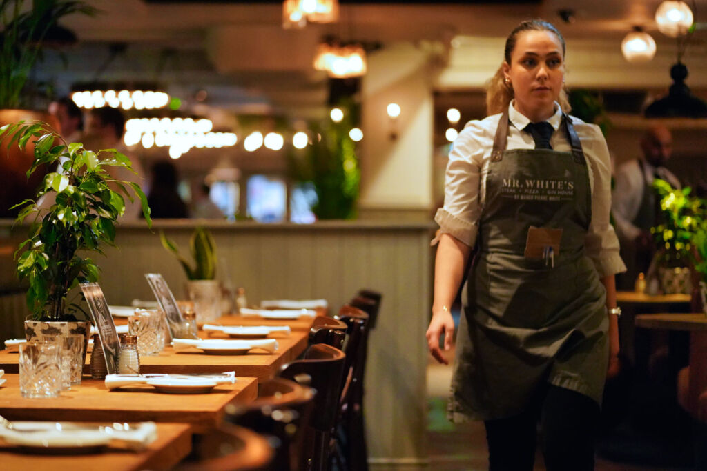 A female member of staff walking through the restaurant