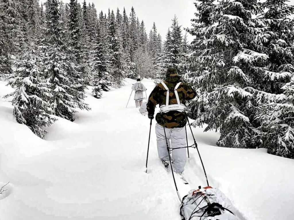 Skiers establishing the Telemark expedition route, pulling sledges through thick snow