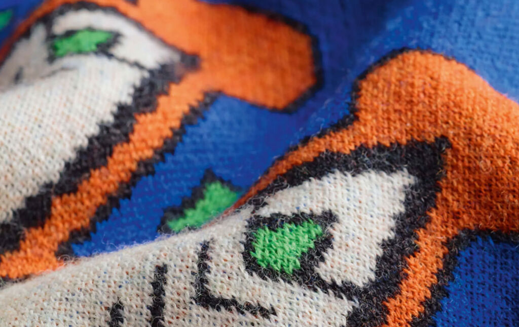 A close up view of the stitching and pattern on the knitwear brand's Yawanawá collection