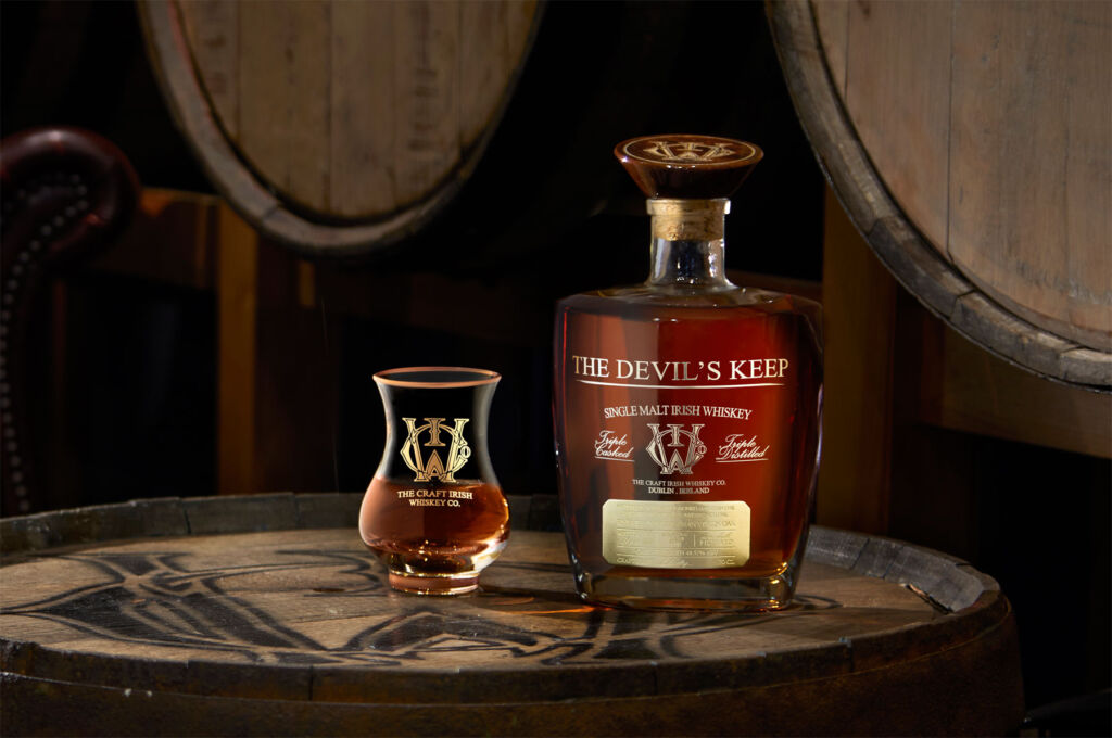 The Deveil's Keep Whiskey with one of its limited edition glasses