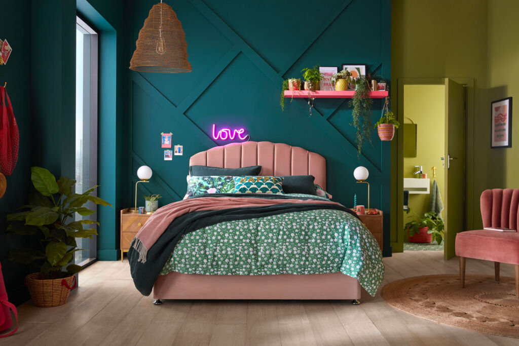 The eco-comfort bedding set in a room with an illuminated sign saying love on the wall