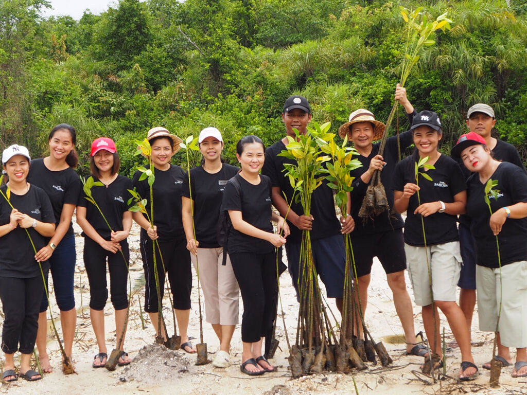 The staff at the Sarojin planting trees to help the environment