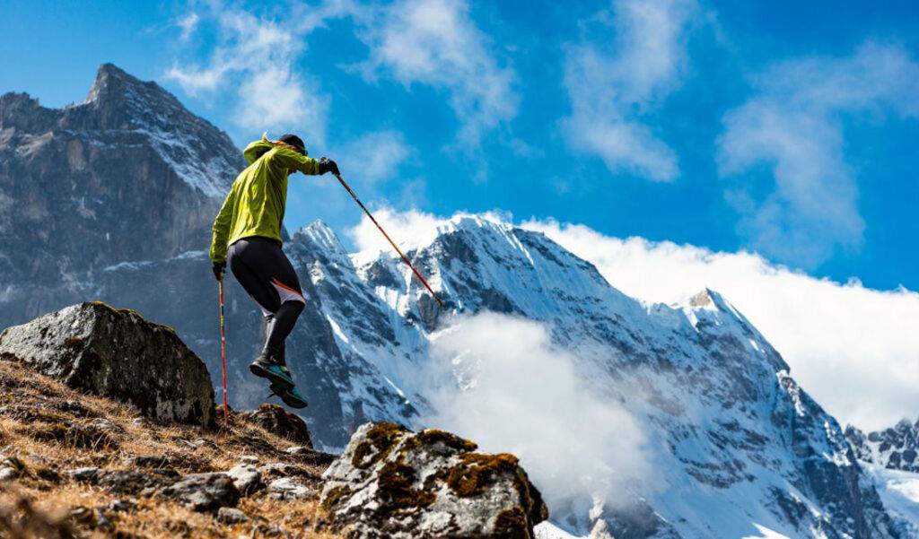 A competitor coming down a slope at speed using hiking poles