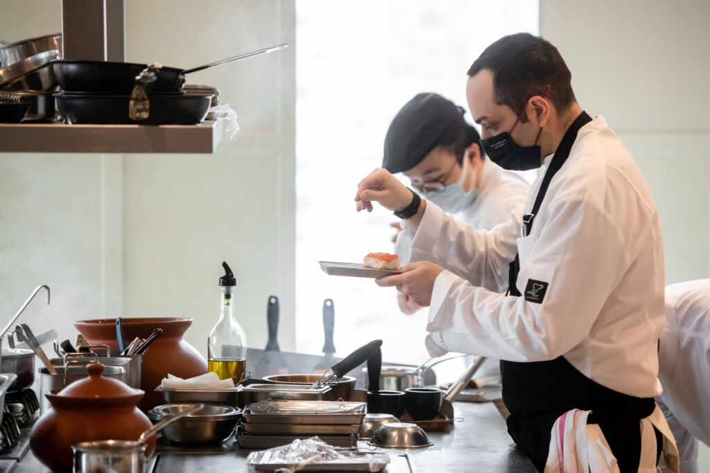 Chef Fabio Nompleggio working in the Glasshouse kitchen with a colleague