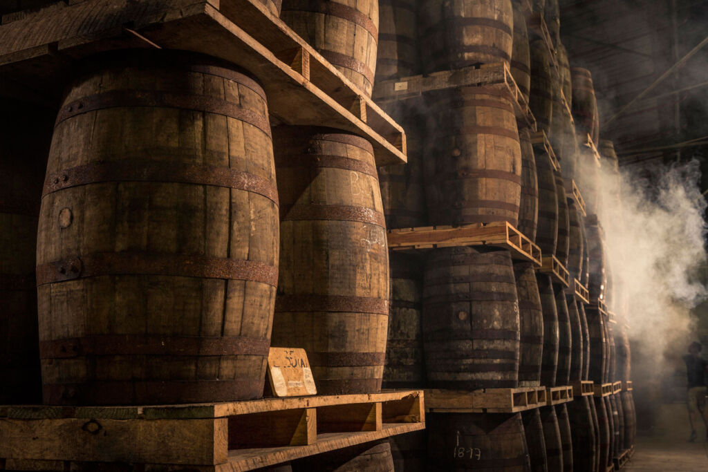 Barrels stacked up on pallets in the distillery
