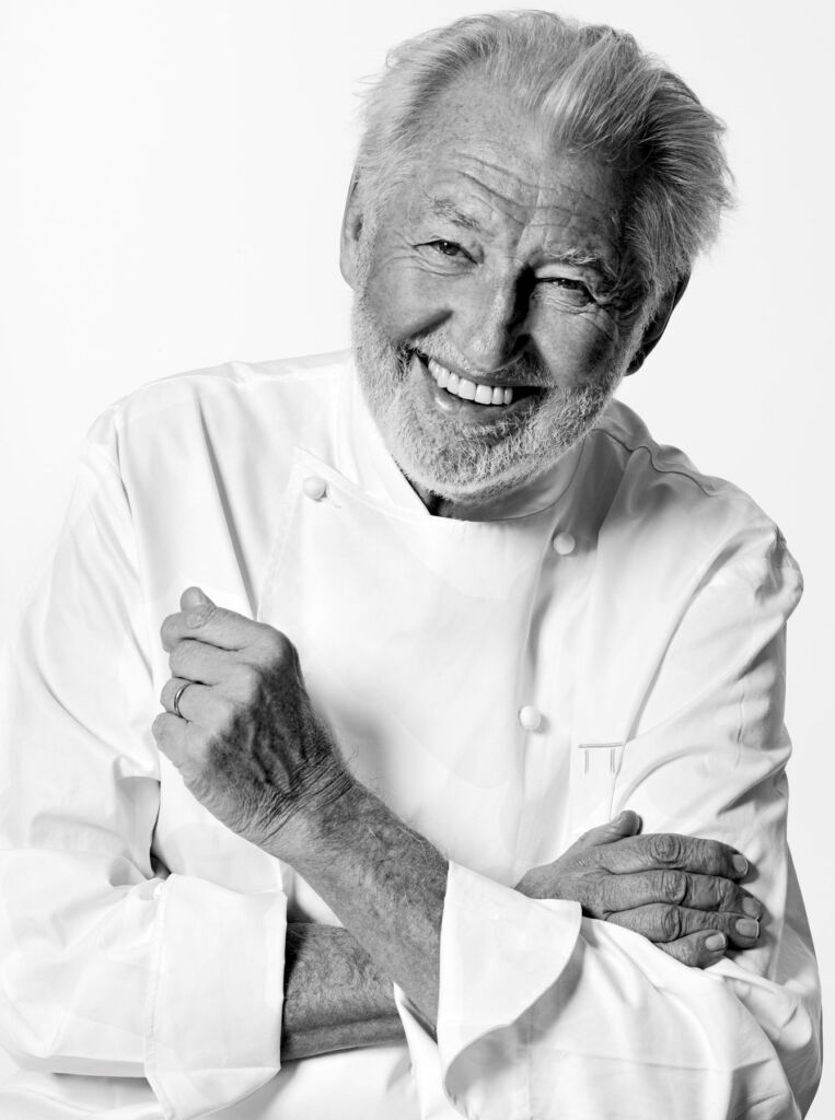 Pierre Gagnaire, laughing with his arms folded
