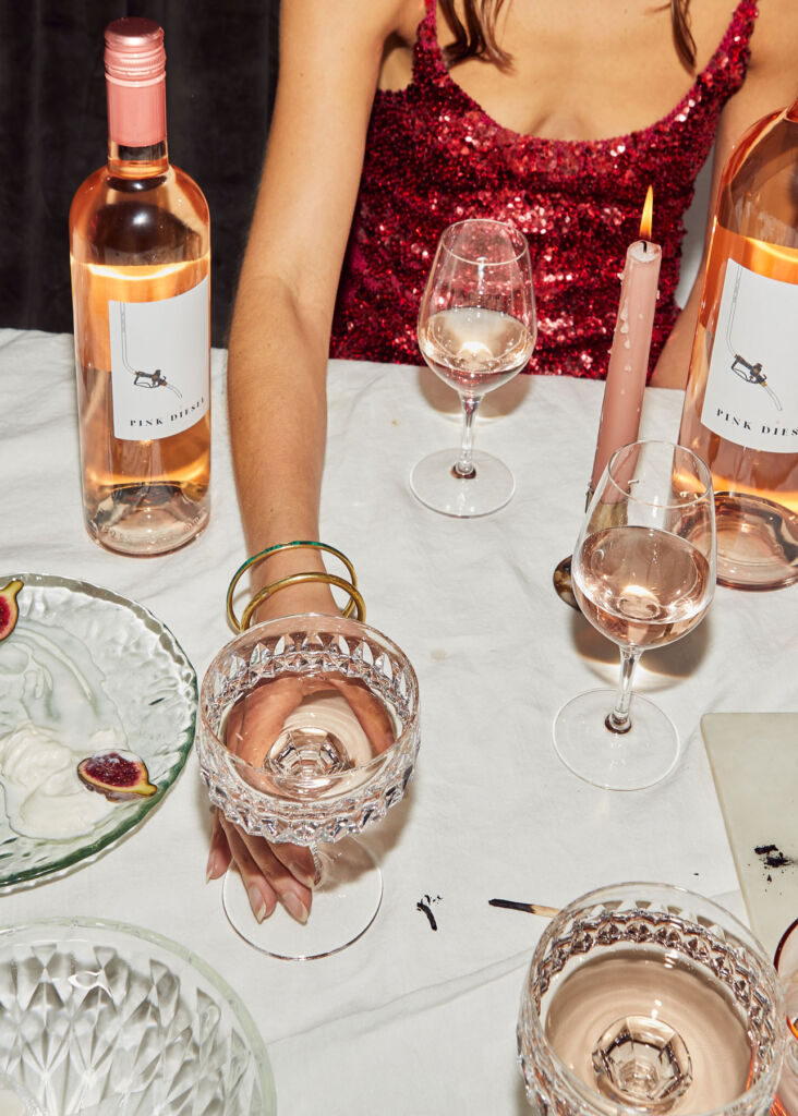 A lady enjoying a glass of the Rosé at a dinner table