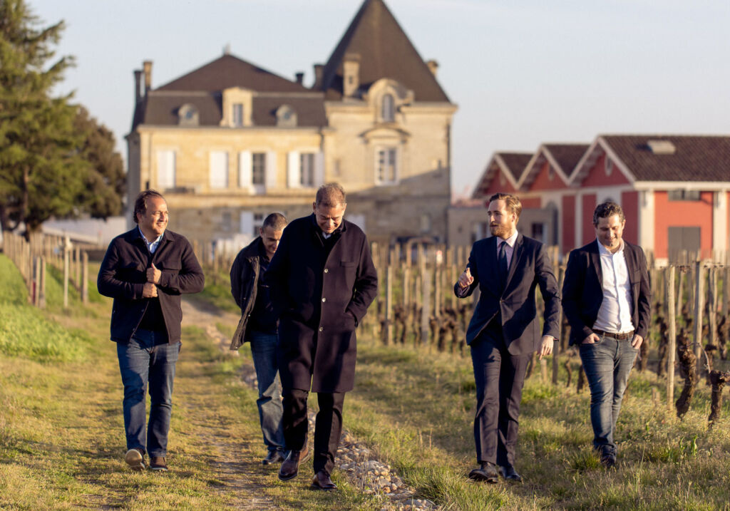 Selim taking a walk through the vineyard with friends