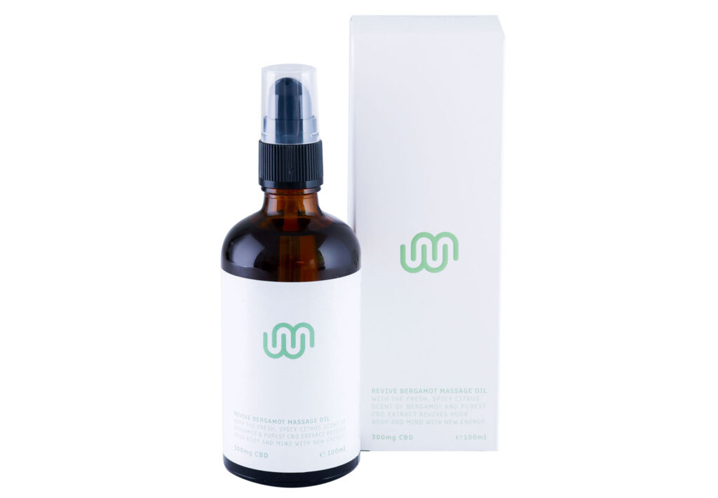 A bottle of Walker & Morland CBD Revive Bergamot Massage Oil next to its box