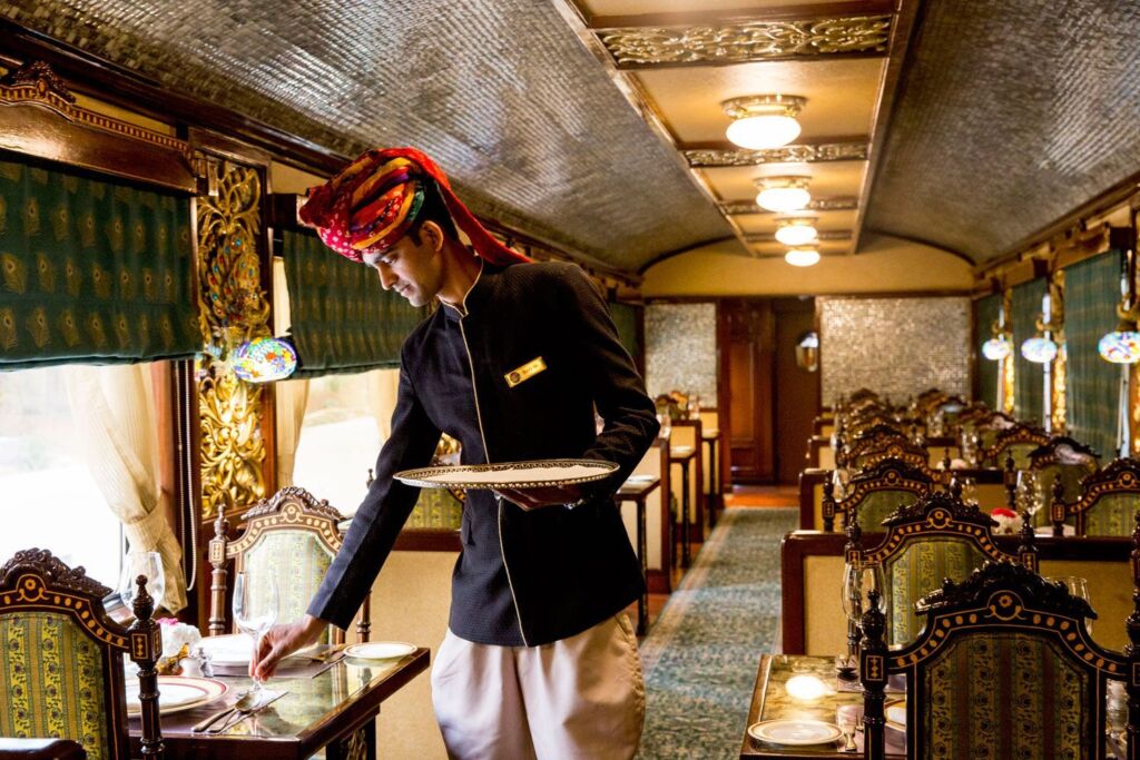 A member of staff serving guests onboard the Maharajas' Express