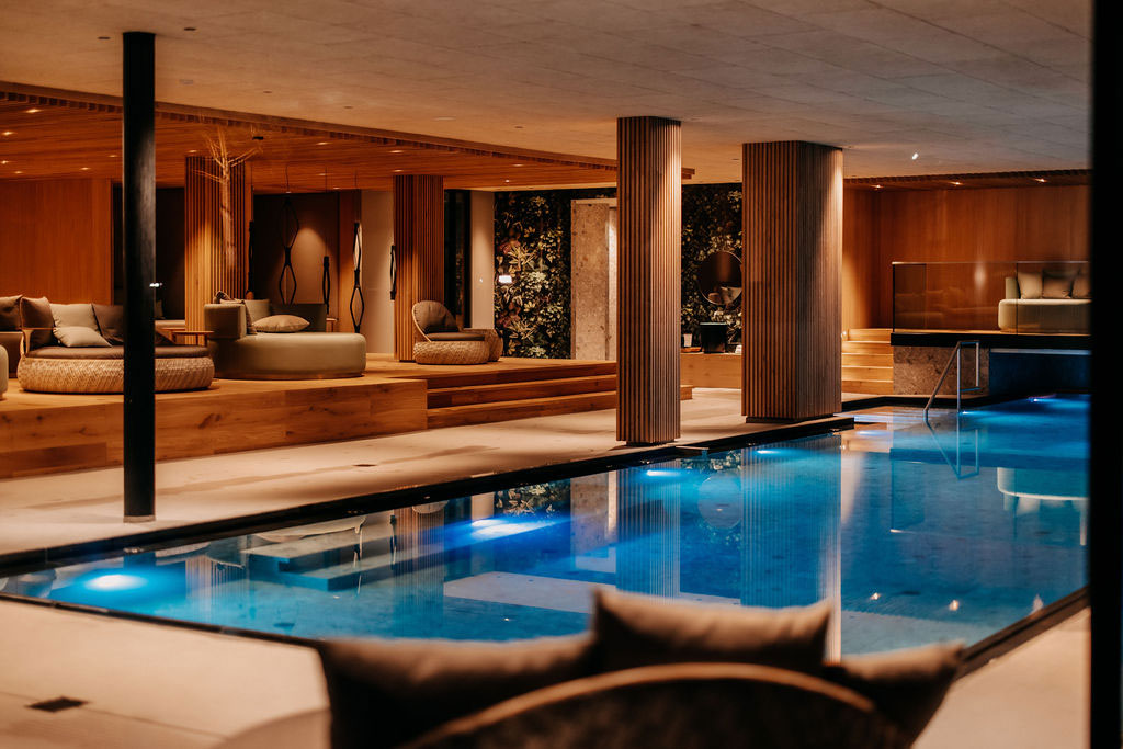 The indoor pool at the spa surrounded by comfortable loungers and seating