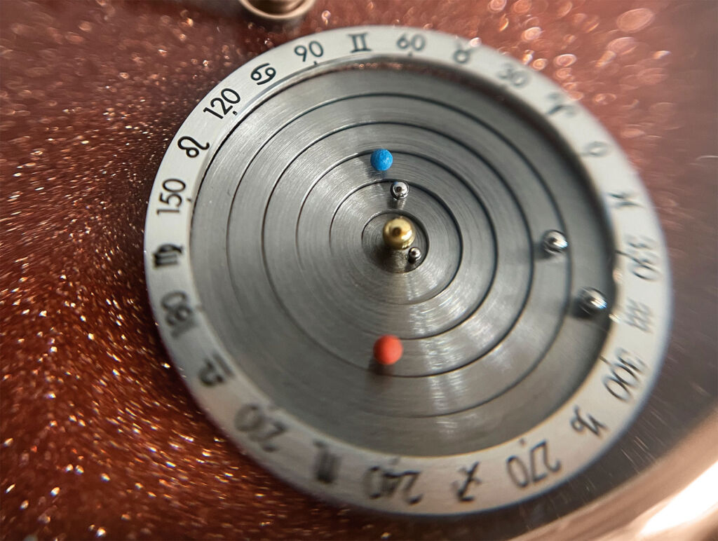A close up view of the planetarium, which is embedded in the watch dial.