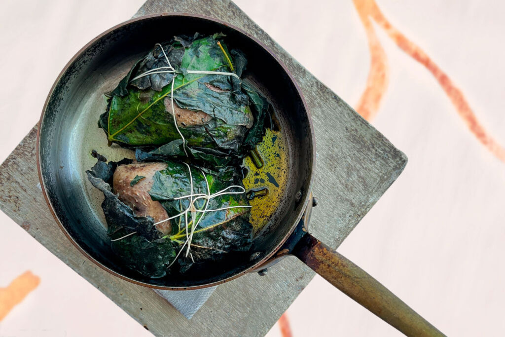 Pigeon from Plouneour Menez wrapped in a fig leaf in a pan