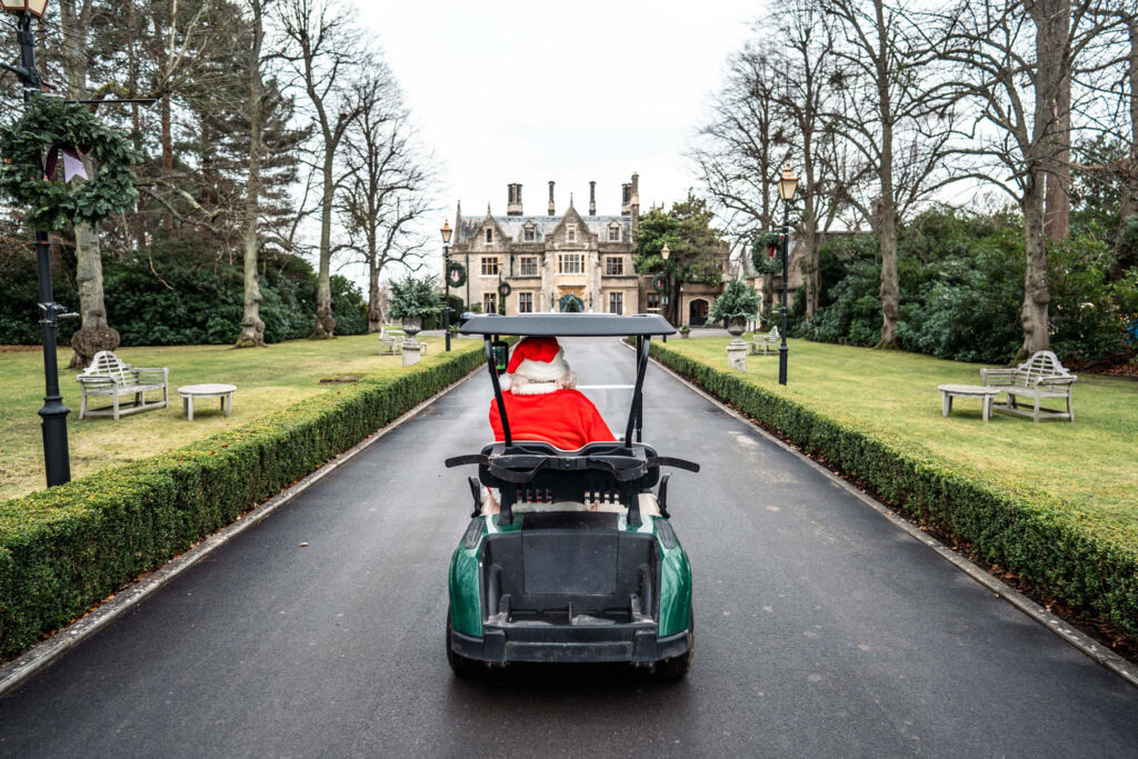 Father Christmas driving an electric buggy up the main driveway