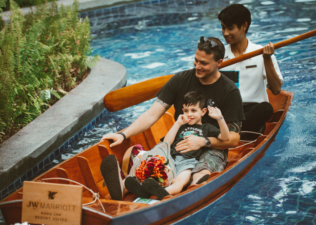 A father and son enjoying a boat trip in the water park