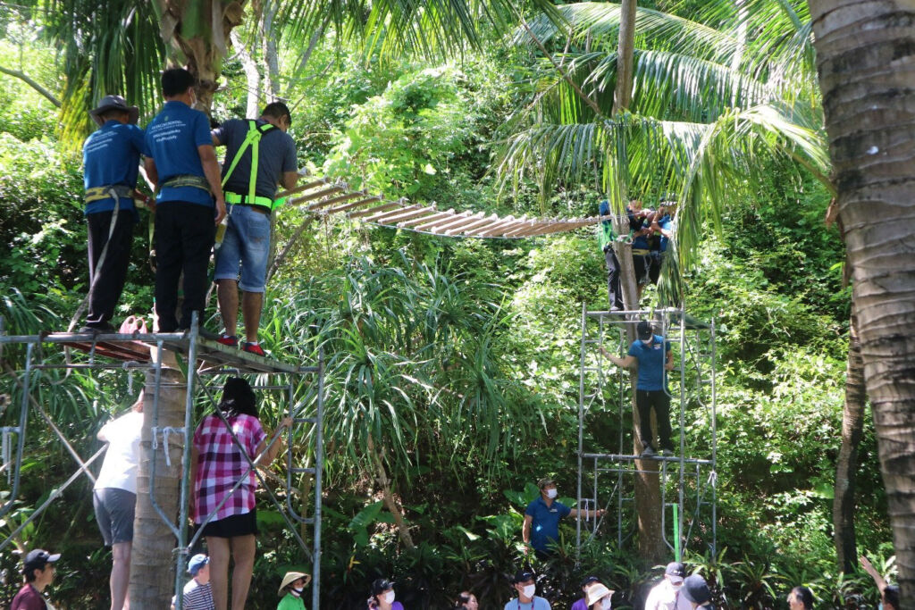 members of the hotel team installing walkways in the trees