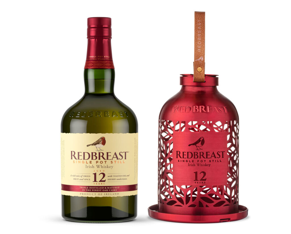 The red bird feeder next to a bottle of the 12-year-old whiskey