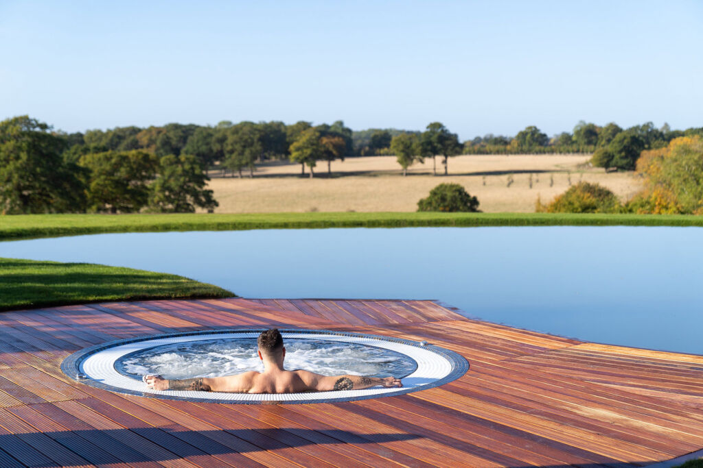 A man in the spa pool enjoying the beautiful seemingly never-ending countryside