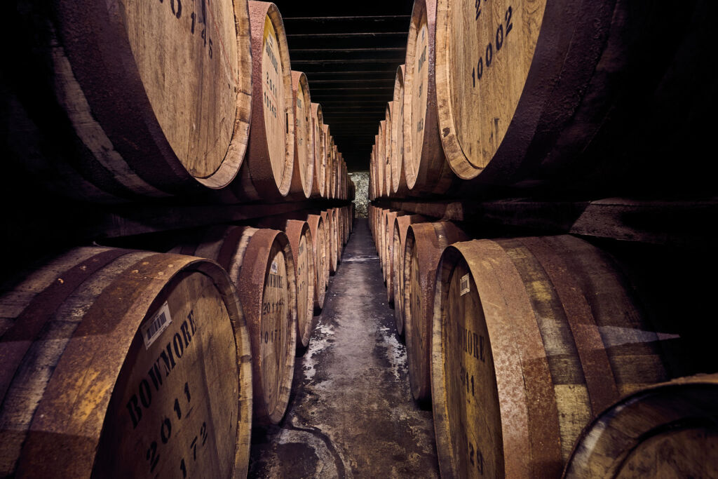 Rows of wooden barrels stored in the cellars