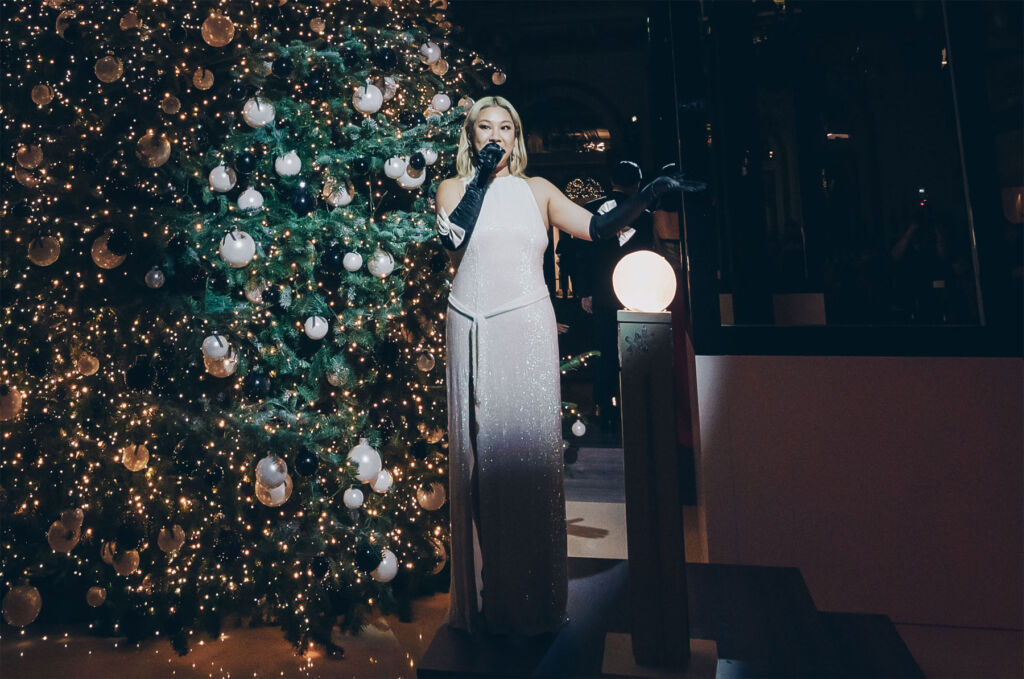 Joyce Cheng singing by the Christmas Tree