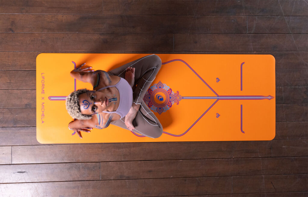 Michela on her personalised orange Liforme yoga mat