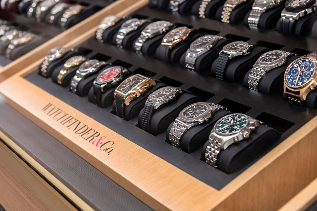 One of the company's wooden display trays filled with high end watches