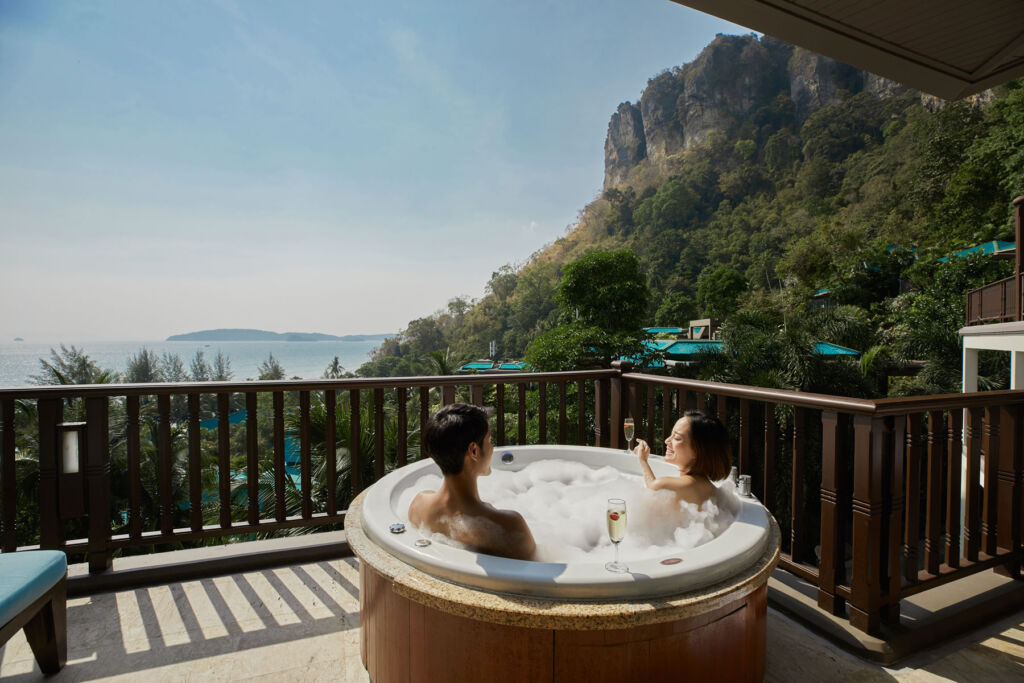 A couple enjoying their private jacuzzi on their balcony