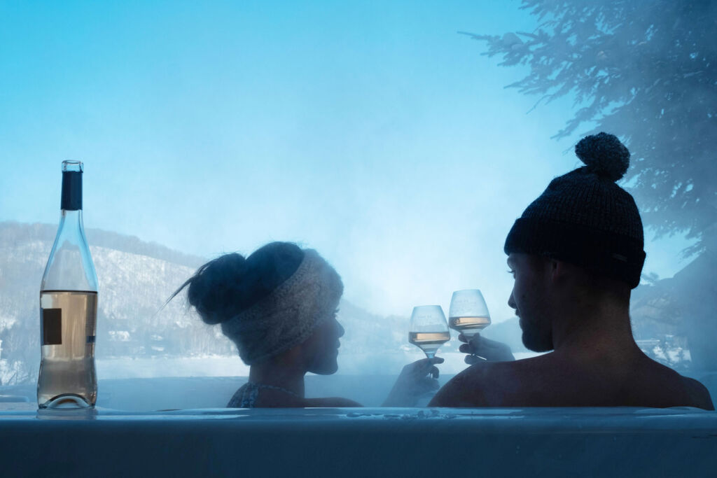 A couple enjoying a glass in a jacuzzi