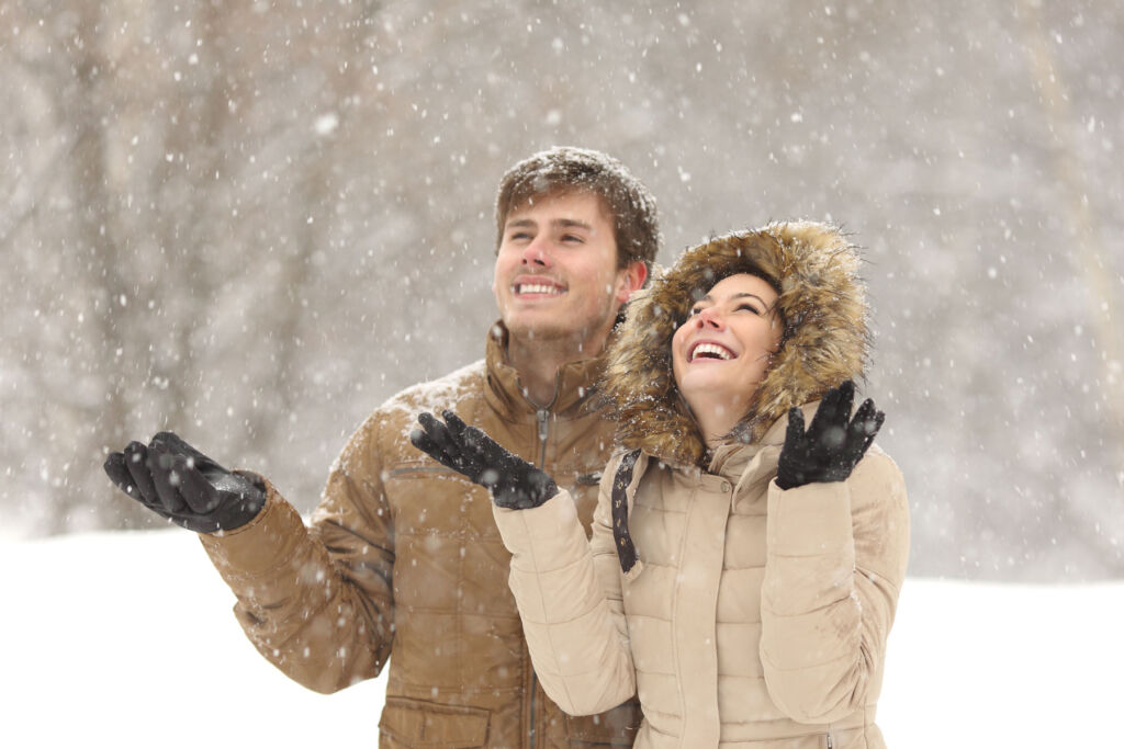 A couple enjoying a light snow flurry