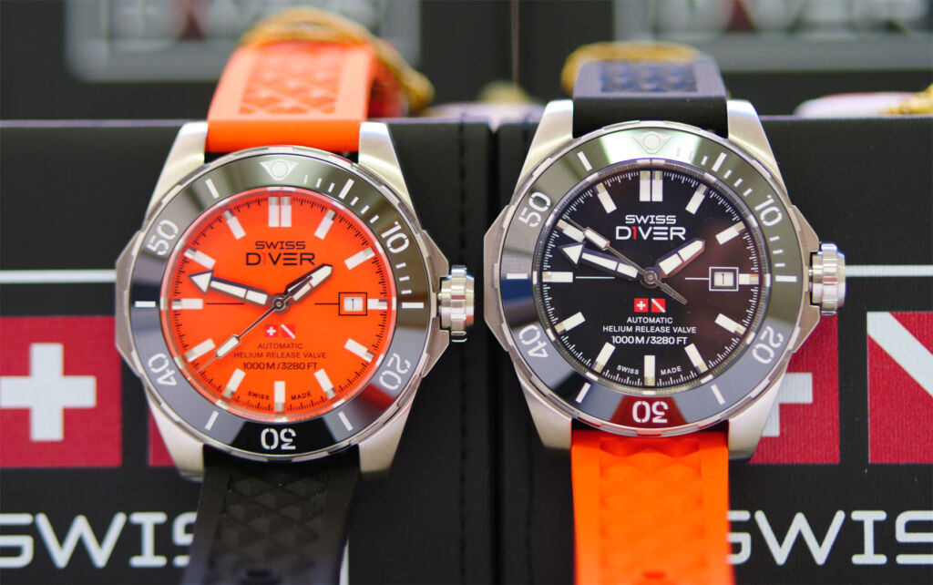 Two Swiss D1ver models, one with an orange dial, the other with a black coloured dial