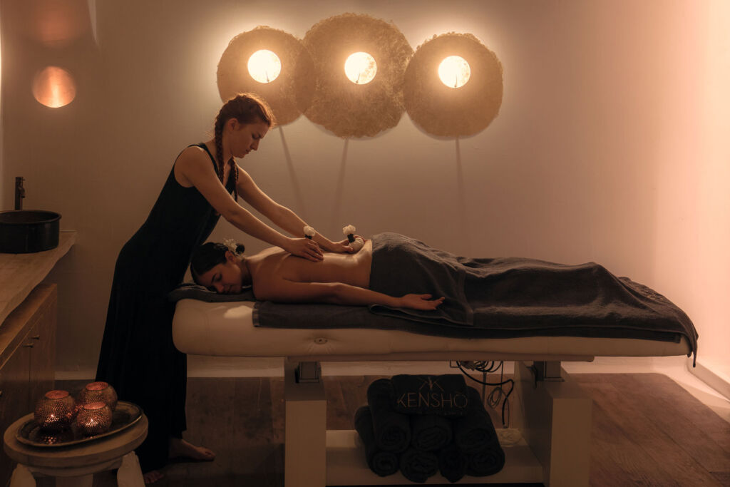 A guest enjoying a massage in one of the spa treatment rooms