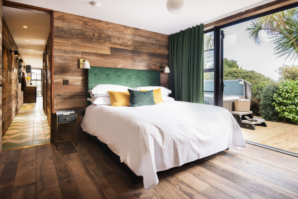Inside one of the bedroom suites with its wood panelled wall and contemporary decoration