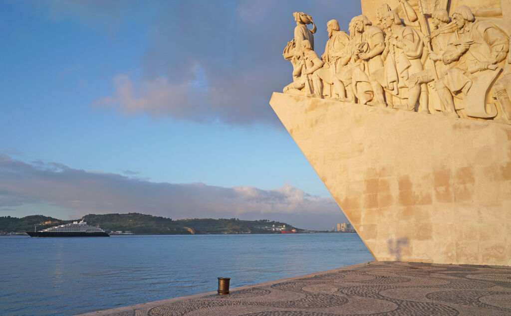 Spectacular carvings in the rock in Portugal with the luxury ship in the background