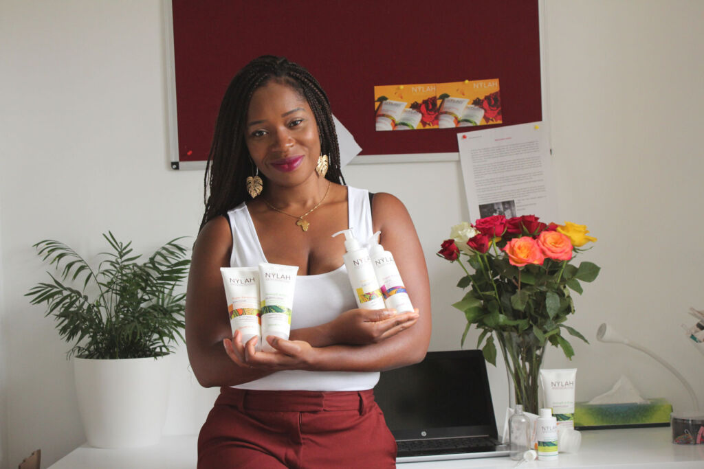 Kam Davis holding a selection of her products