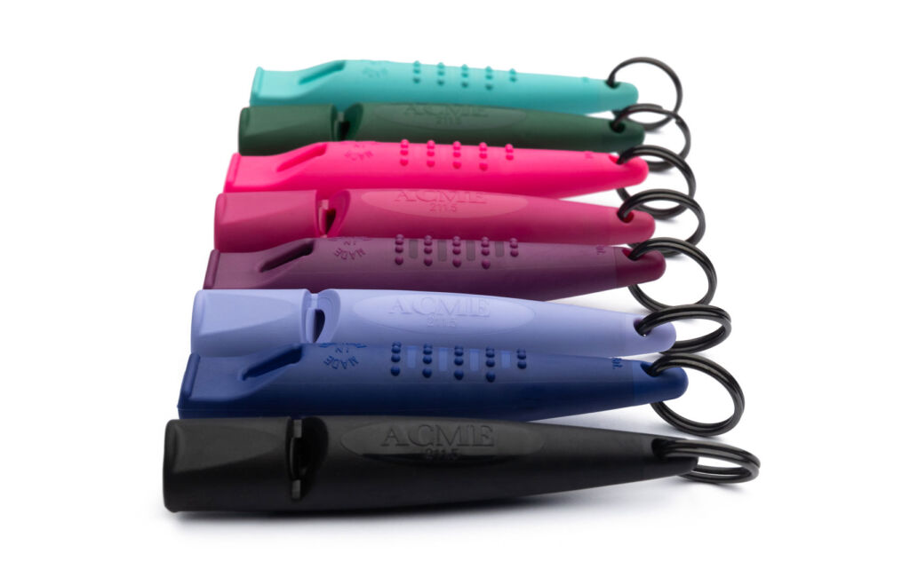 An image showing seven whistles, all in different colours