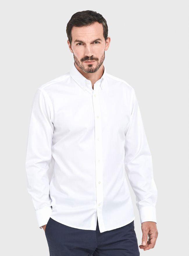 A male model wearing one the brand's white cotton shirts